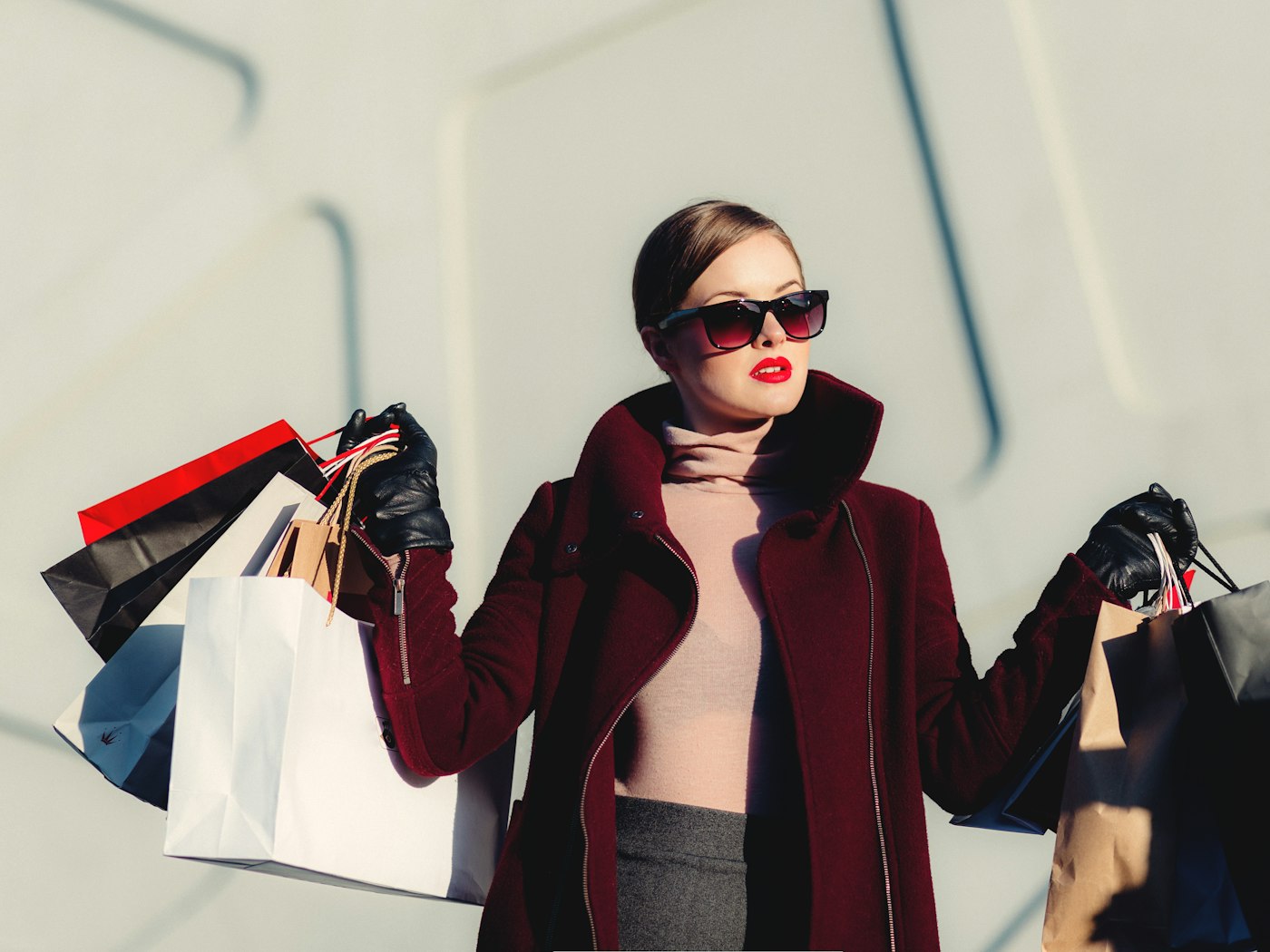 Shopper carrying bags through a fashion boutique